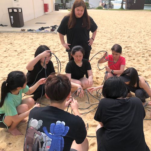 telephone game Effective Communication Training Through Beach Team Building - Scentopia Singapore