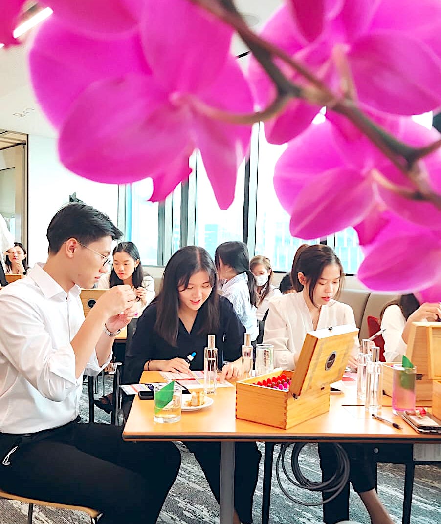 team at their office, making orchid perfume at an event